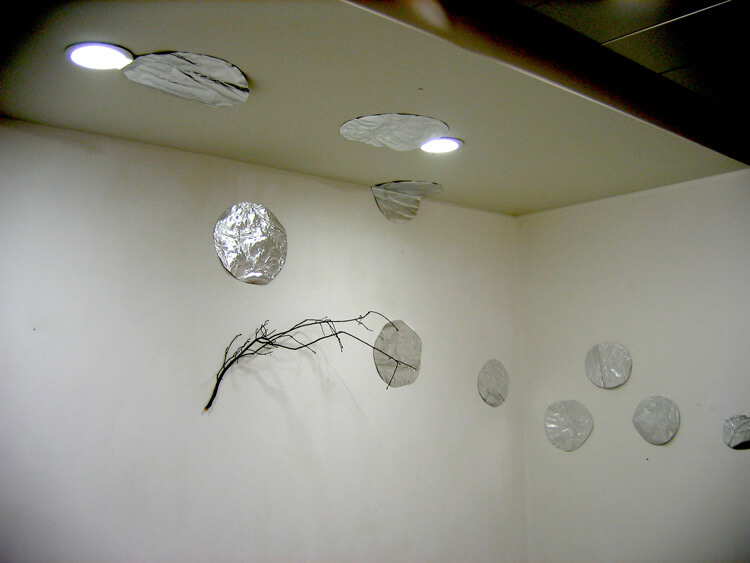 Silver Circles and a Twig, 2005, paper, aluminium foil, twig and glue, variable size